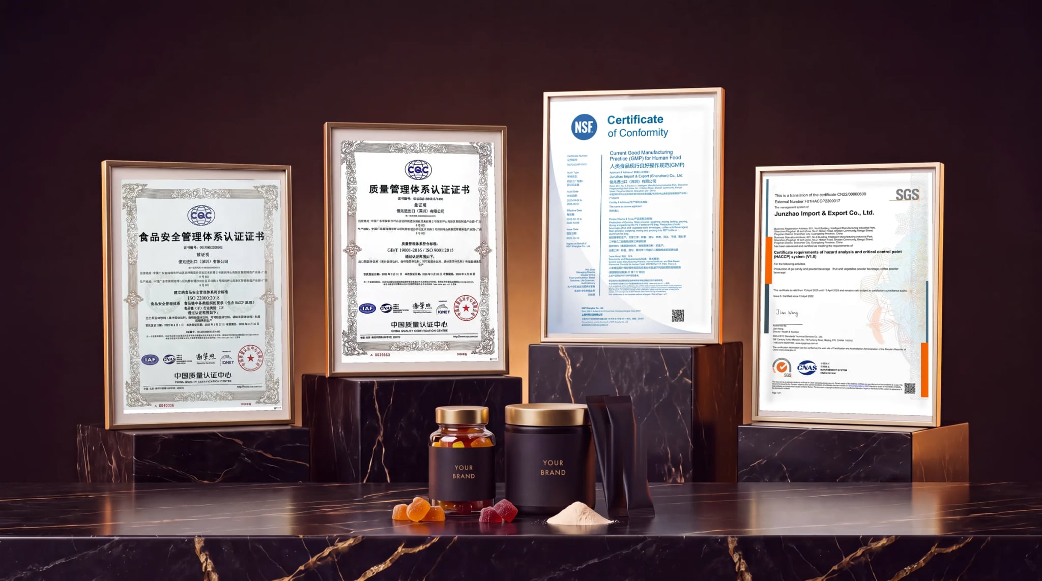 The four certificates held by Junzhao Import & Export (Shenzhen) Co., Ltd., framed on the production bench